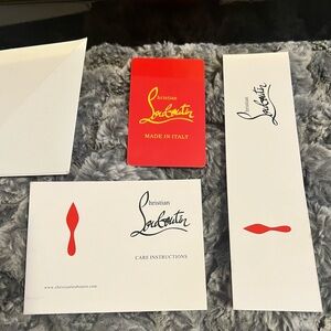 Cristian Louboutin authentication card, bookmark and care instructions.